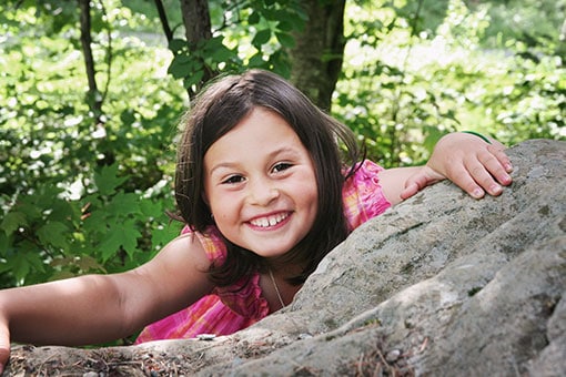 Anabelle Guay lorsqu'elle était enfant, en train d'escalader un rocher.